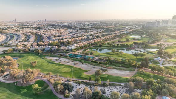 Aerial View to Villas and Houses with Golf Course with Green Lawn and Lakes Timelapse