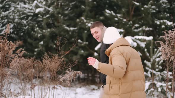 Loveling Couple of Young People Hav Date in Forest in Winter