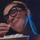 Woman watching a romantic comedy movie at the cinema and eating popcorn, entertainment concept - VideoHive Item for Sale