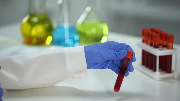 Scientist Marking Tube With Red Substance, Blood Analysis, Vaccine Development