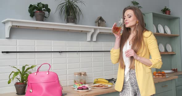 Businesswoman Hurrying and Drinking Glass of Juice