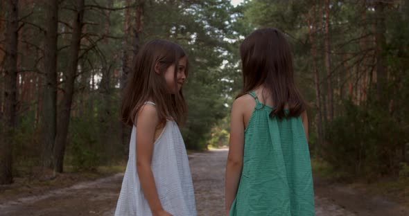 Two Beautiful Girls Walking in the Woods