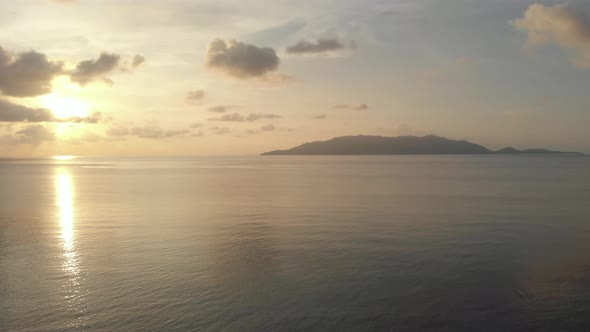 Aerial: flying over tropical Hatta island white sand beach Banda Islands Maluku