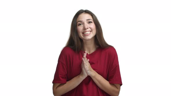 Cute Brunette Girl in Red Tshirt Asking for Help Saying Please and Smiling Holding Hands Together