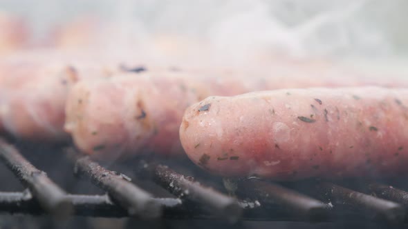 Fresh raw mixed meat sausages on the barbecue close-up 4K 2160p 30fps UltraHD footage - Close-up tas