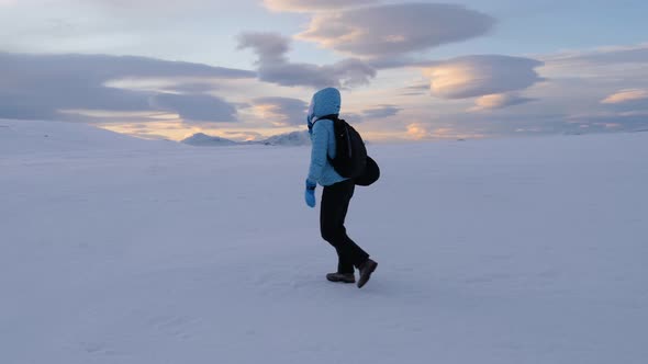 Girl walking on Storsteinen mount over Tromso City, Norway, Arctic
