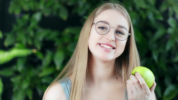 Smiling Beautiful Young Girl Posing with Fresh Eco Apple at Summer Green Tree Natural Background