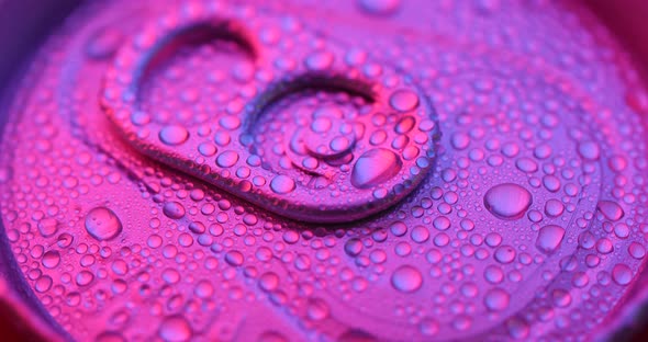 Beer can with water droplet with purple light