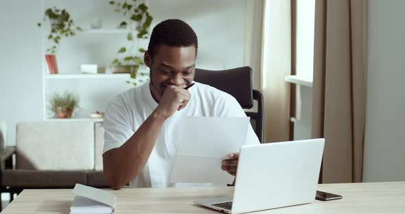 Headshot Attractive Afro American Guy Read Positive News in Letter Feels Happy Celebrate Success Win