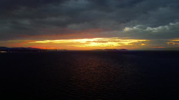 aerial view of sunrise in the city  , above sea in cloudy winter day