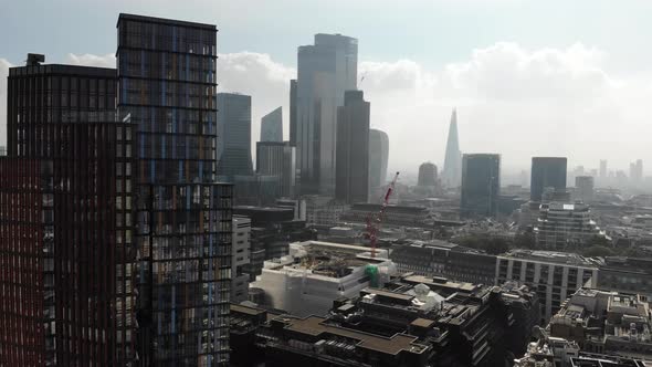 Fly-past skyscrapers near Liverpool Street Station revealing the London skyline on a hazy day