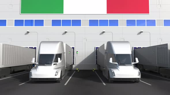 Trucks at Warehouse Loading Dock with Flag of ITALY