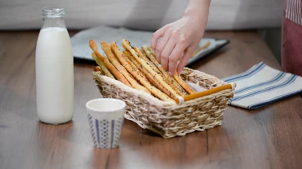 Grissini Breadsticks, Sesame-Covered Bread Sticks. Fresh bread sticks in a basket.