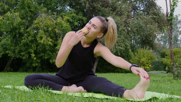 Girl Stretches on Exercise Mat and Bites Off Pie