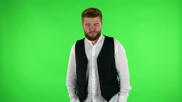 Man Is Offended and Looks Away, Then Smiles. Green Screen
