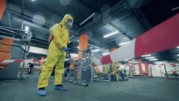 Sanitary Inspector Is Spraying Chemicals in a Gym During Pandemic