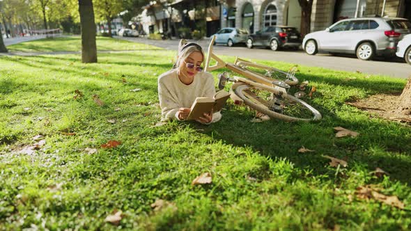 Woman Reading Book in Park in Spare Time