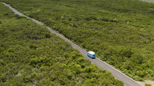 Aerial shot of VW-Campervan following on a scenic road on Madeira, Portugal