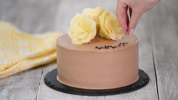 Pastry chef decorate cake with chocolate.	