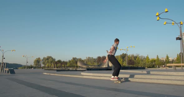 Skater Boy Is Doing Tricks at the Park, Kickflip and Jumps, 