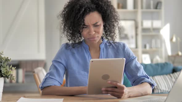 Sad African Woman in Awe for Lose on Tablet