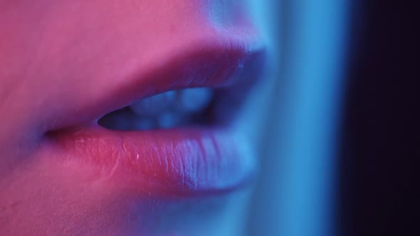 Female Lips in Neon Light Closeup