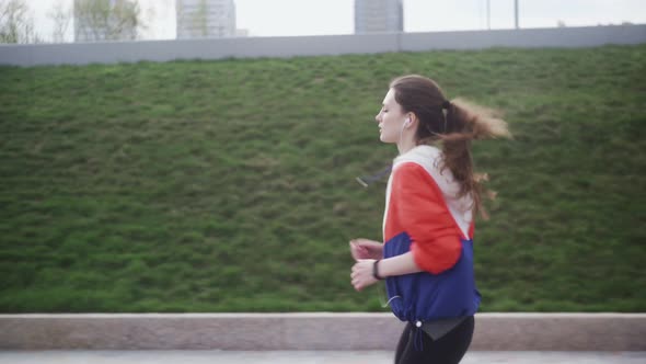 Runner Woman Running in Park Exercising Outdoors Fitness Tracker Wearable Technology