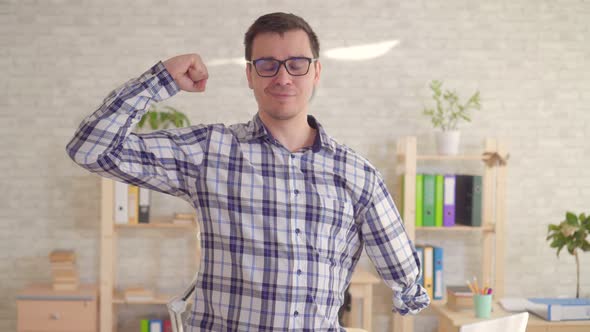 a Strong Positive Male Disabled with an Amputated Hand Poses in the Camera