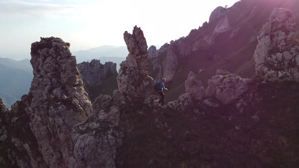 Hiker enjoying view from rocks, Lecco, Lombardy, Italy