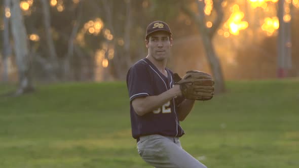 A young man playing catch with a baseball.