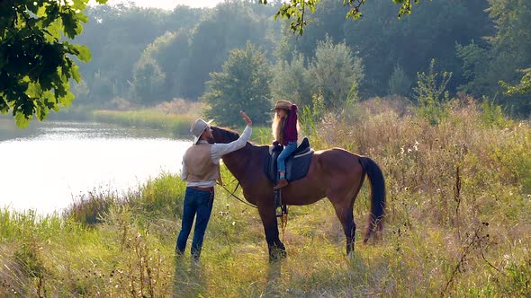 Cowboy and His Daughter on Horseback