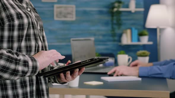 Close Up of Old Woman Employee Texting on Tablet