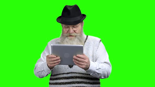 Senior Man Playing Video Game on Tablet Pc