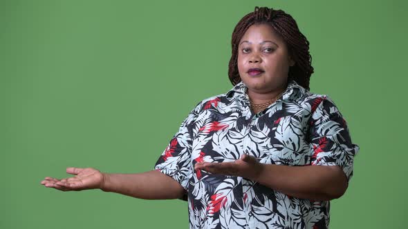 Overweight Beautiful African Woman Against Green Background