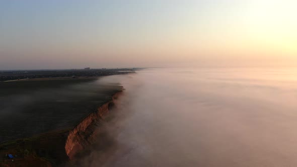 A foggy sunrise on the sea shore