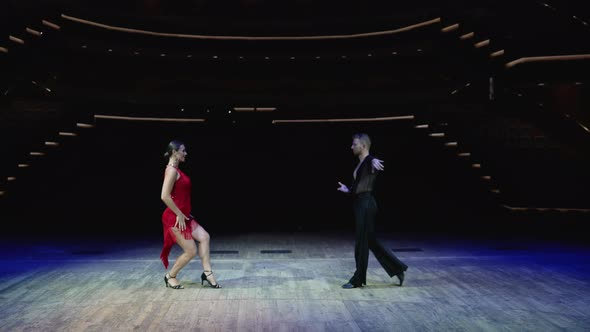 A Girl in a Red Ball Gown and a Guy in a Black Bodysuit