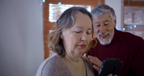 an Elderly Couple a Man Scares His Wife Talking on a Smartphone