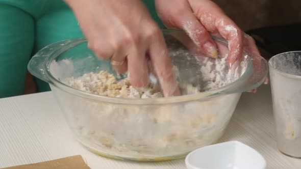 A Woman Is Stirring The Dough For Making Biscuit Cookies.