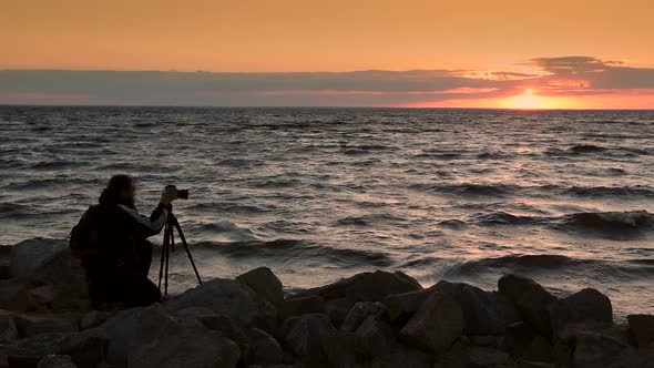 Man Photographing Beautiful Sunset at Seaside