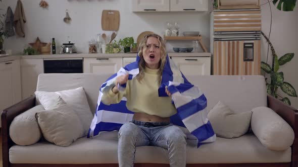 Attractive Greek Woman Sports or Football Fan at Home with the Flag of Greece