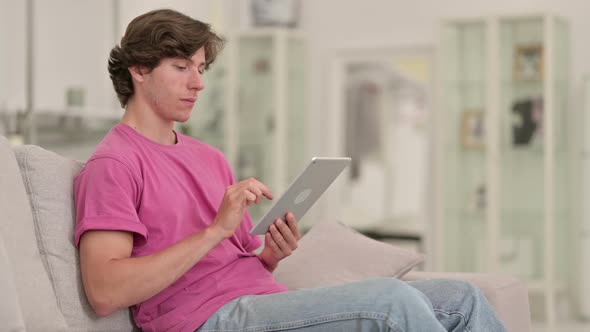 Professional Young Casual Man Using Tablet at Home