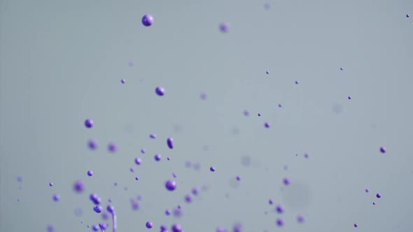 Purple Paint Flying Into Air Creating Abstract Patterns