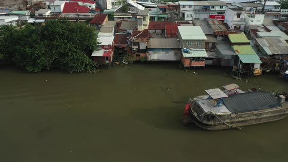 Saigon, Ho Chi Minh City, Vietnam early morning drone tracking shot over Kenh Te canal, traditional