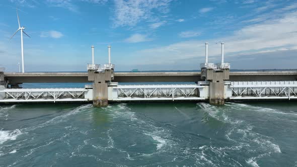 Sea Water Rushing Through a Storm Surge Barrier Protecting the Mainland