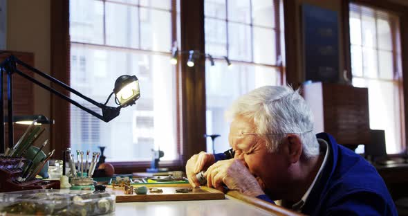 Horologist repairing a watch