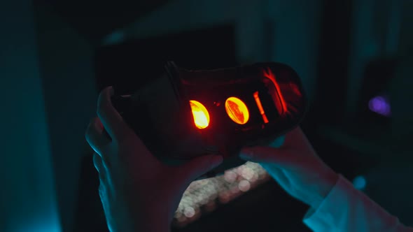 Player Puts on 3d Virtual Reality Glasses in Neon Style