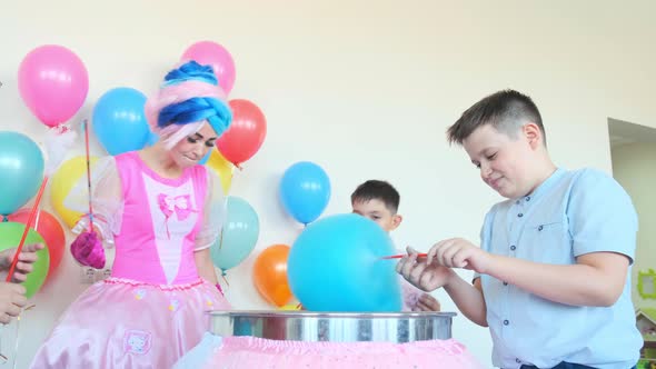 Smiling Boy Makes Blue Cotton Candy with Friends at Birthday