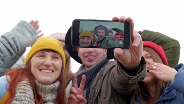 Group of Young Hipster Friends Make Selfie with Smartphone Camera. on the Background of Autumn