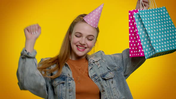 Teen Girl Showing Shopping Bags Advertising Discounts Low Prices Shopping on Black Friday Holiday