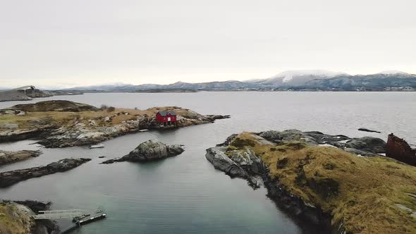Aerial View Of Red Boathouse On Edge Of Island In Atlantic Ocean In Norway.